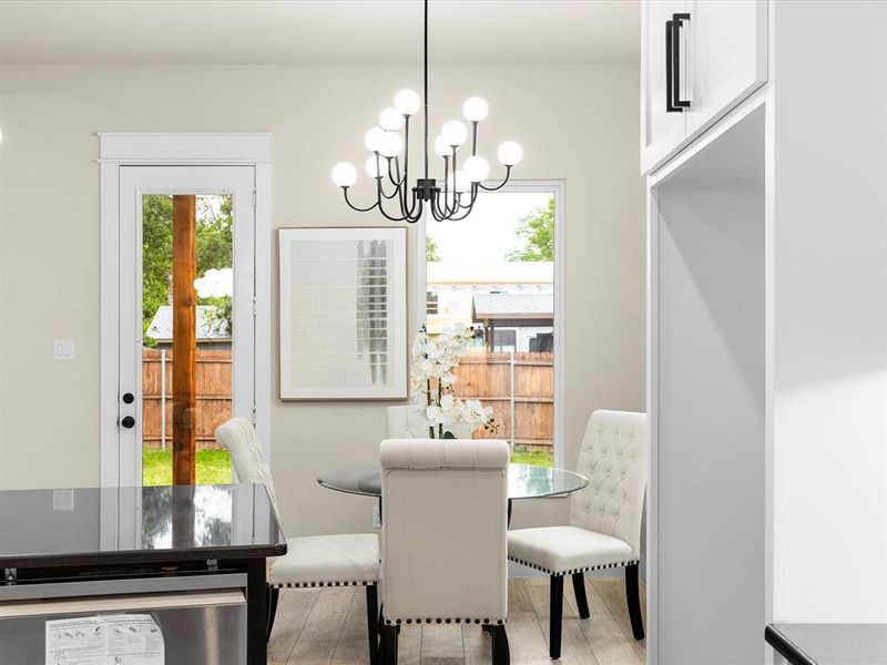 Dining area with a chandelier and light wood-style floors
