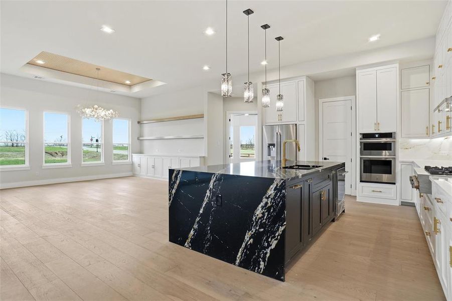 Designer kitchen with waterfall island overlooking the dining area and flexible living space ideal for entertaining.