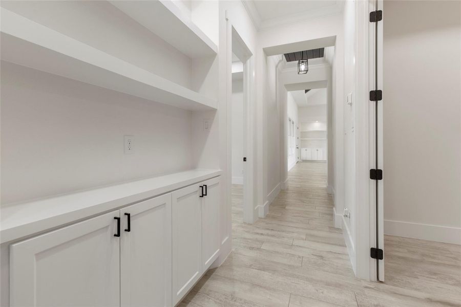 The hallway offers built-in cabinets and shelves for an abundance of storage. This is perfect because it is just outside the media room. The hallway offers built-in cabinets and shelves for an abundance of storage. This is perfect because it is just outside the media room.