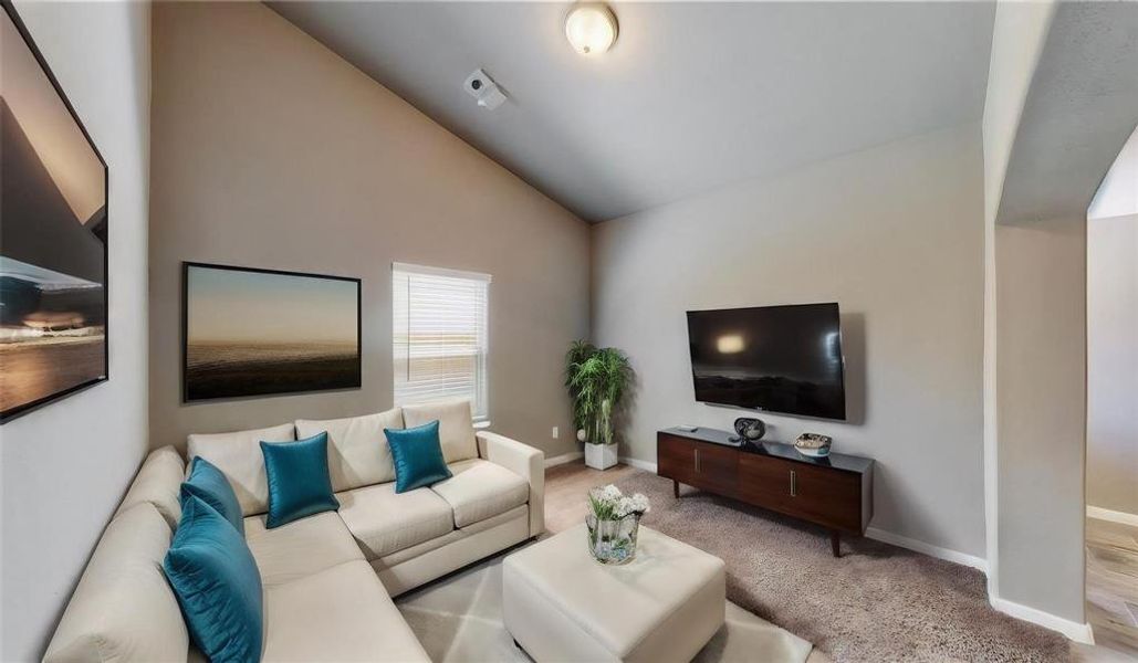 This versatile room with a high ceiling and arched entryway offers a perfect space for a home office or a cozy guest room. Its neutral color palette and natural light create a welcoming atmosphere, making it a great canvas for your personalized touches. This is a picture of an Elise Floor Plan with another Saratoga Homes.