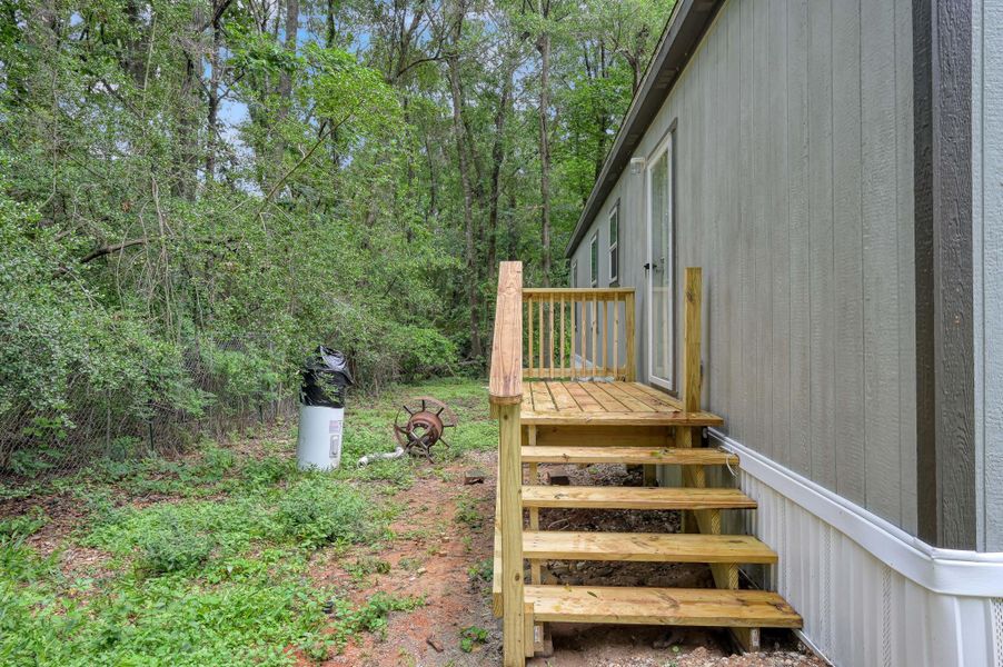 Exterior details and patio area of a home in , New Waverly (Image 14).