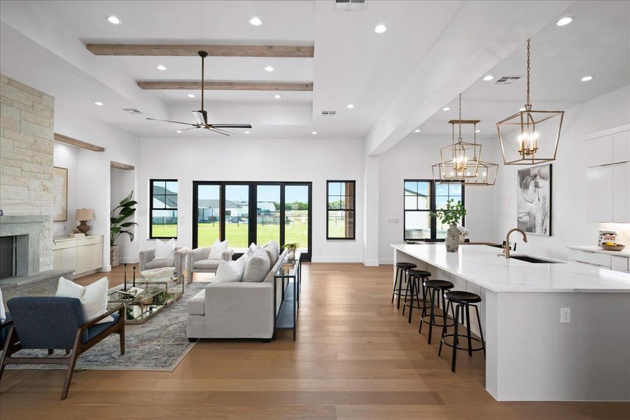 Living area with recessed lighting, light wood-style flooring, a chandelier, a fireplace, and a ceiling fan