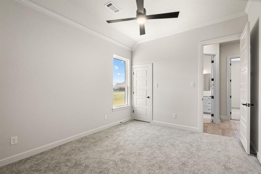 Guest Bedroom has Carpet, Ceiling Fan & Deep Walk-In Closet