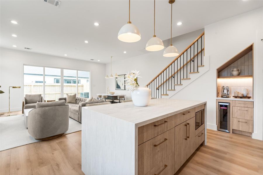 This is where the good life happens — cooking, laughing, lingering long after the meal is done. The openness of the space makes it feel like there's always room for one more person to pull up a seat.
