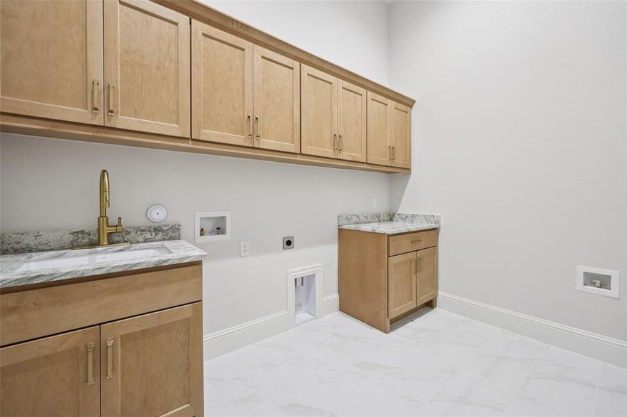 Laundry room featuring hookup for a washing machine, electric dryer hookup, cabinet space, and light marble finish floors