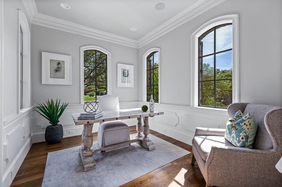 Office with plenty of natural light, crown molding, and dark hardwood / wood-style flooring