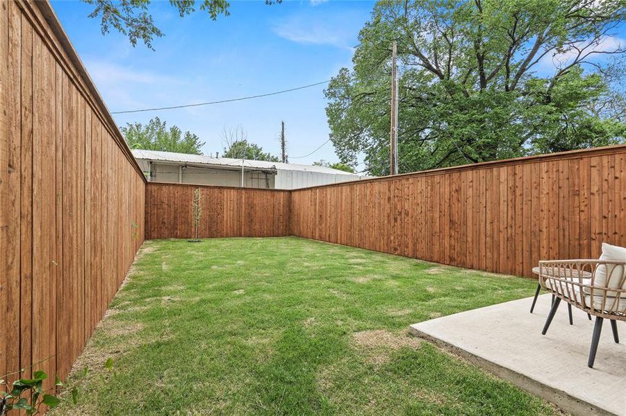 View of yard featuring a fenced backyard and a patio