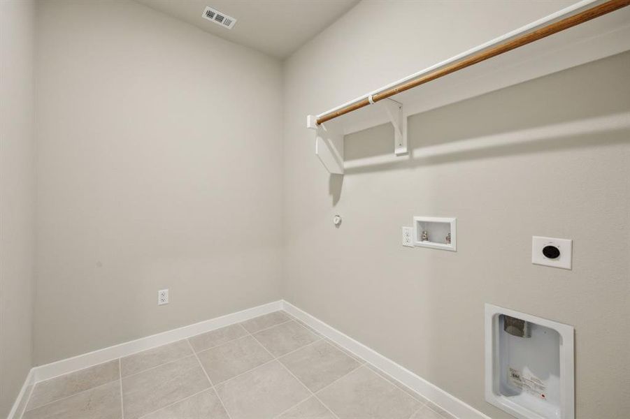 Laundry room featuring open storage and extra room