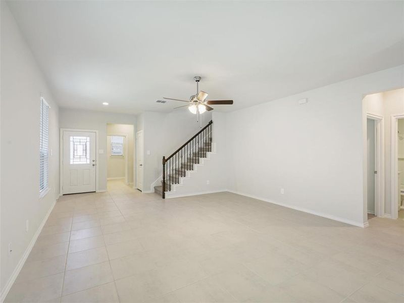 Foyer featuring stairway, a ceiling fan, recessed lighting, and baseboards Foyer featuring stairway, a ceiling fan, recessed lighting, and baseboards