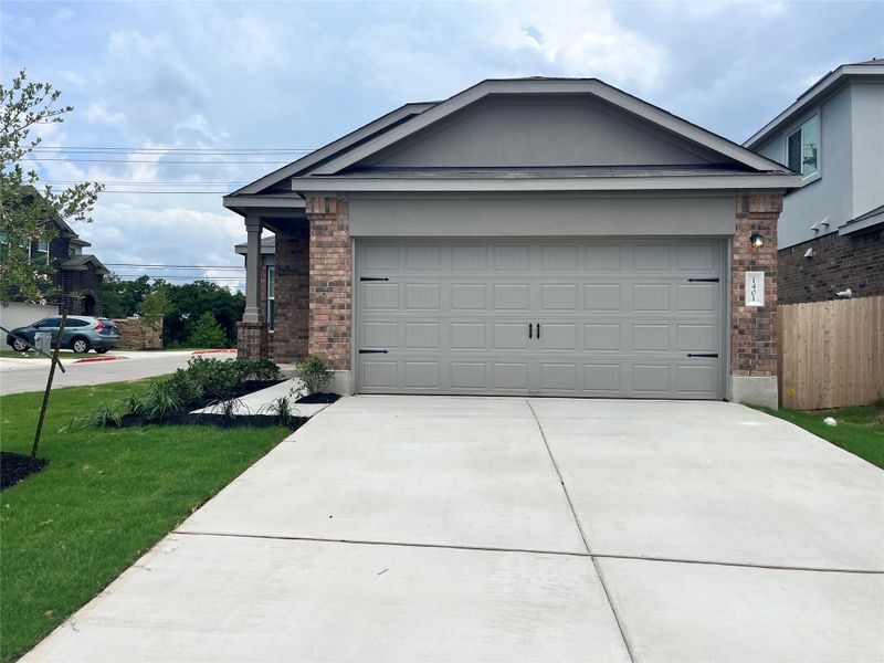 Front exterior of a new home in Woodfield Preserve: Ridgepointe Collection, Georgetown, TX, highlighting curb appeal (Image 1).