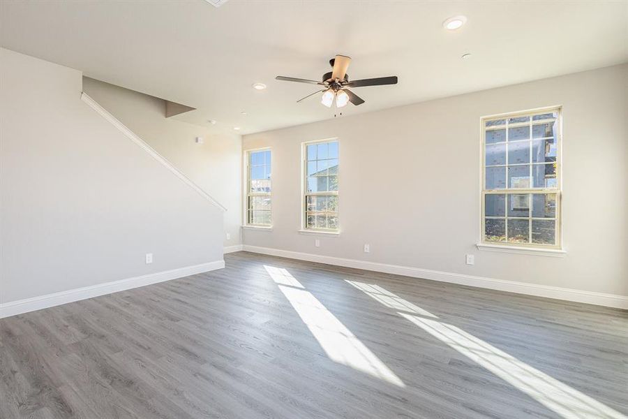 Spare room with hardwood / wood-style floors and ceiling fan