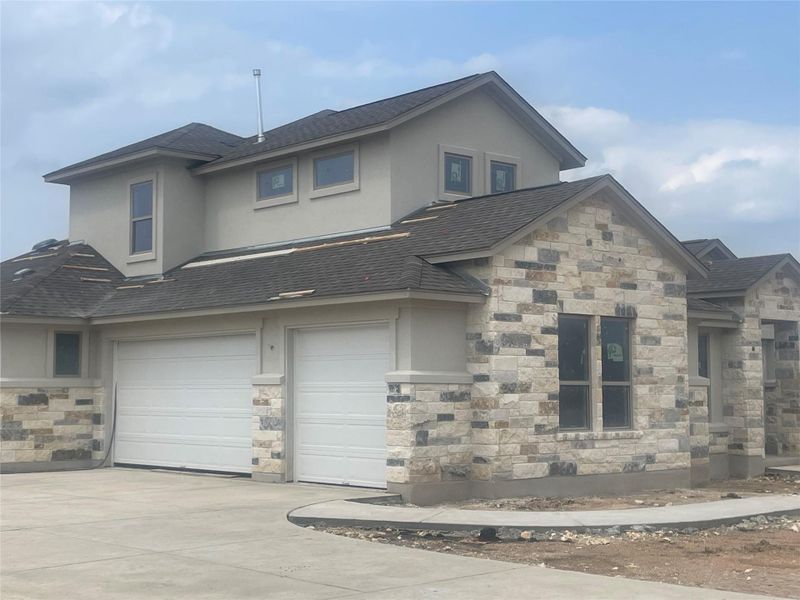 Front exterior of a new home in Leander Estates, Leander, TX, highlighting curb appeal (Image 17).