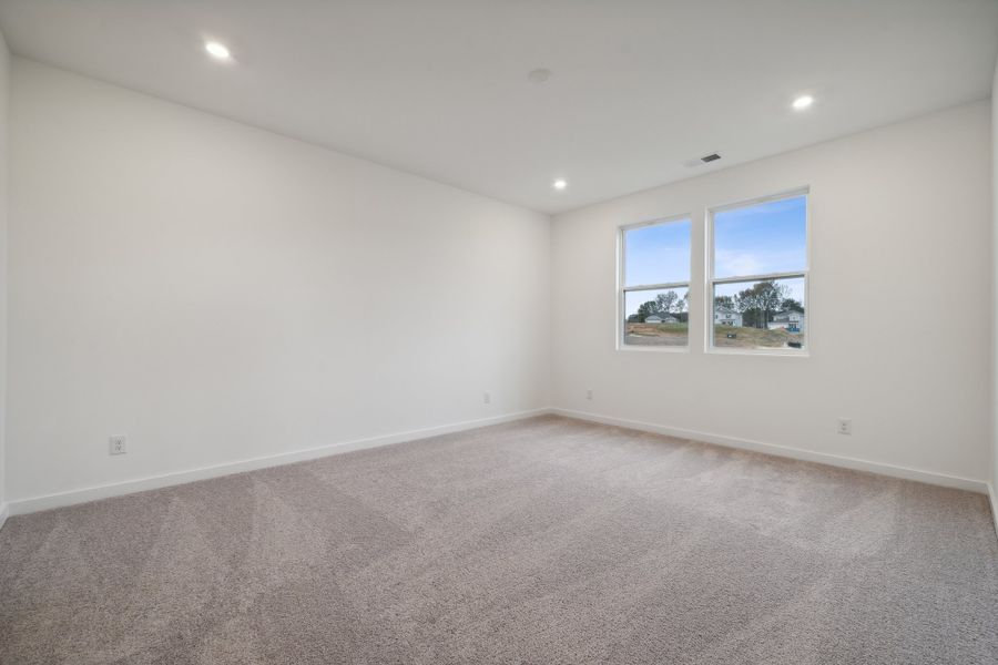 A room with a carpet and windows. A room with a carpet and windows.