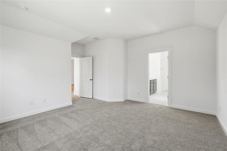 Unfurnished room featuring light carpet, recessed lighting, and lofted ceiling