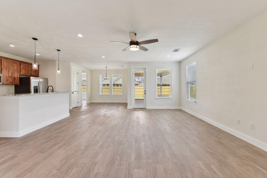 Unfurnished living room featuring recessed lighting, light wood-type flooring, and visible vents