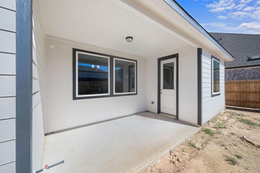 The covered patio is generously sized, providing ample space for various outdoor activities.