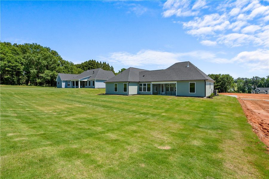 A verdant backyard stretches behind a charming res A verdant backyard stretches behind a charming res