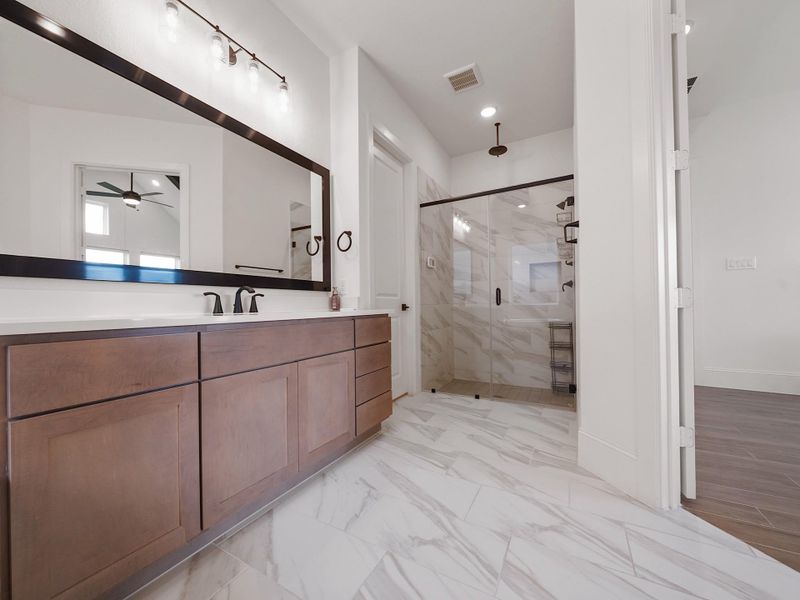 The oversized walk-in shower with tile surround is a showstopper, offering a true spa experience right at home.