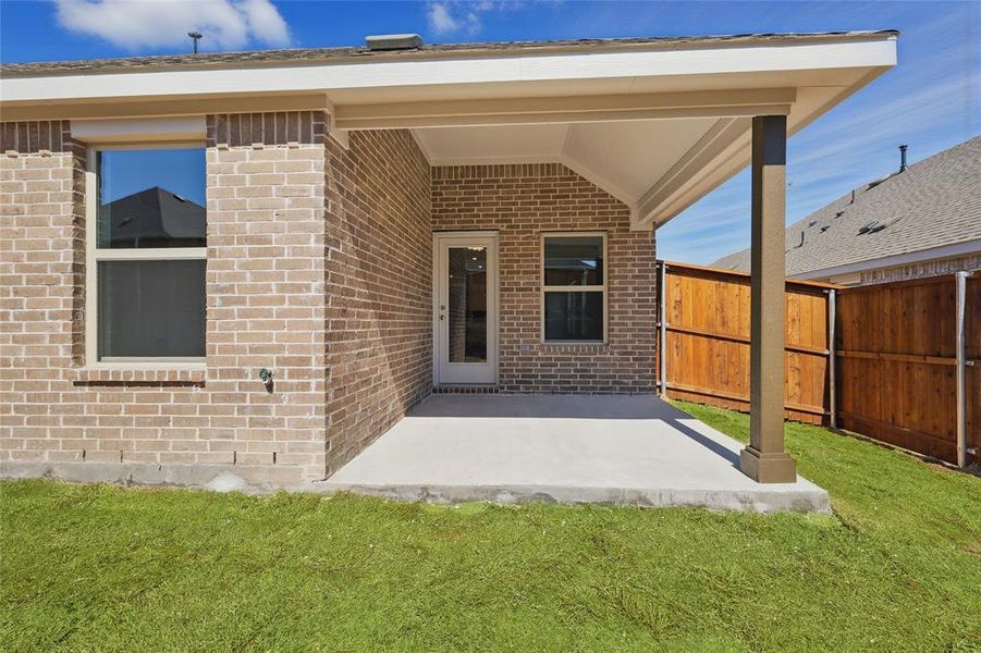 Entrance to property with brick siding and fence