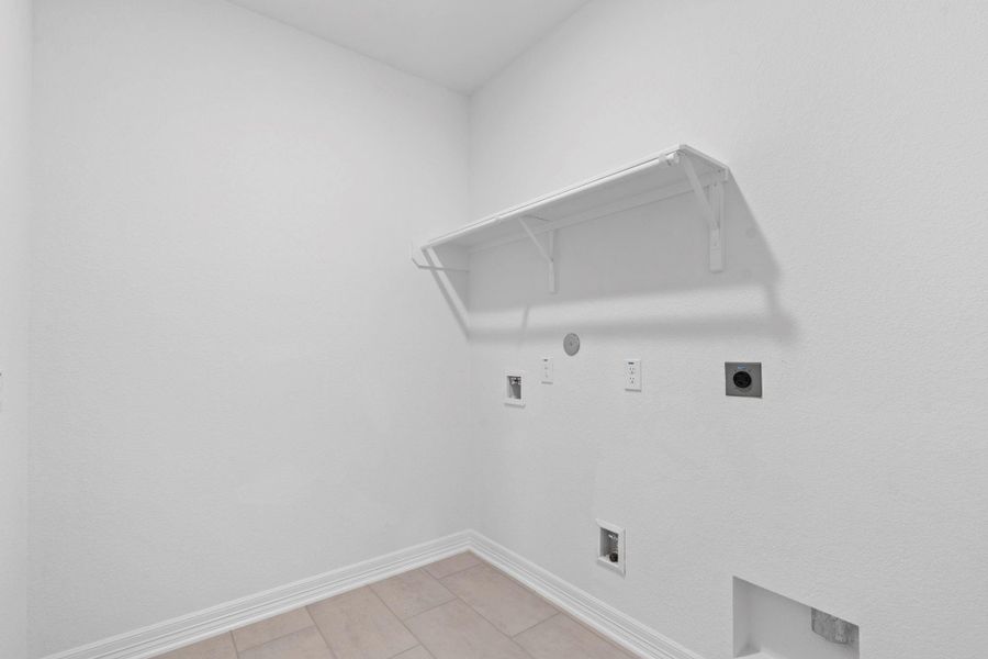 The laundry room layout is carefully planned for optimal workflow with designated areas for washing, drying, and storing.