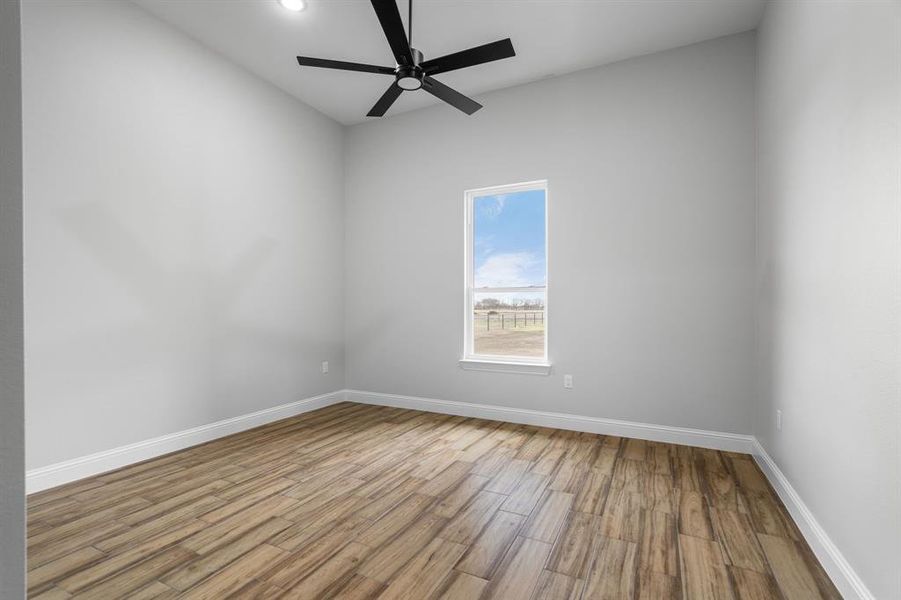 Empty room featuring ceiling fan and wood-type flooring