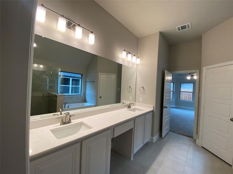 Dual vanity with Monet quartz counters and white cabinets