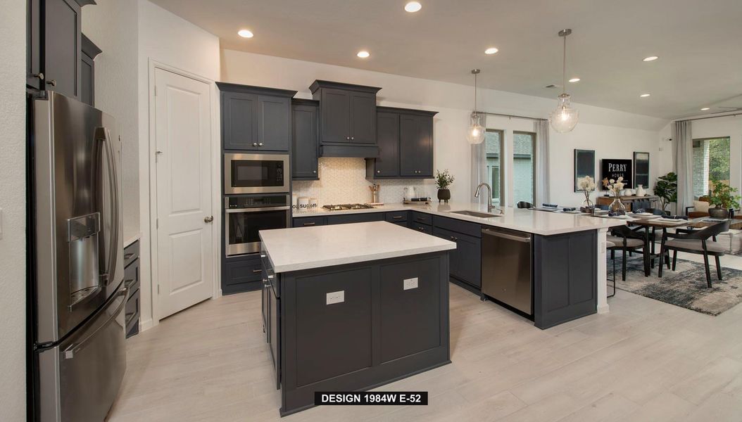 Kitchen featuring decorative light fixtures, stainless steel appliances, backsplash, recessed lighting, and a peninsula