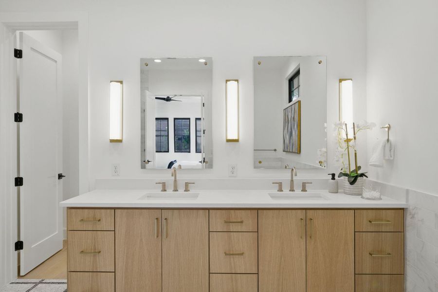 Full bathroom featuring double vanity and a ceiling fan