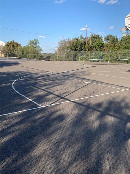 View of sport court featuring basketball and tennis court