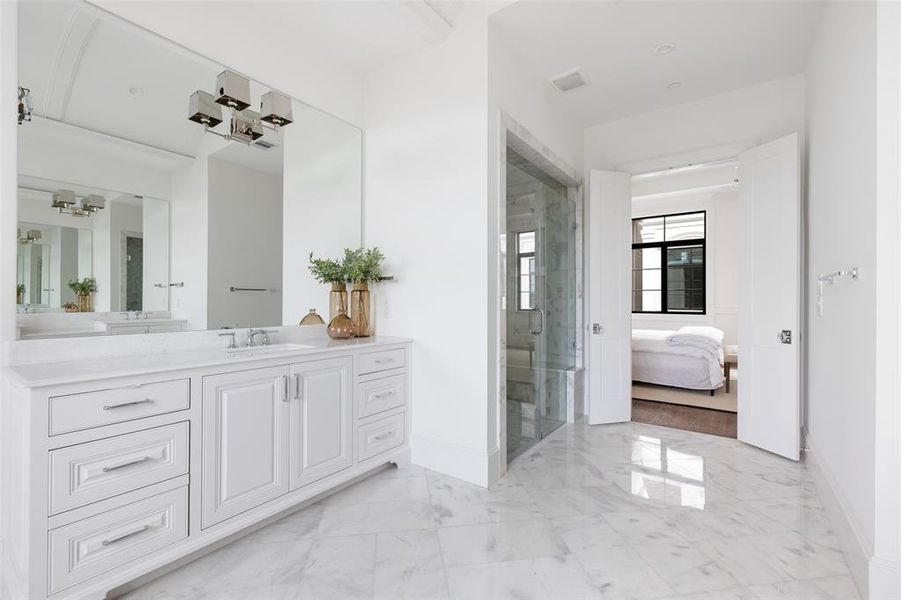 Dual vanity areas will feature marble countertops, statement lighting, and furniture style built in cabinetry. Image from previously completed home in the community.