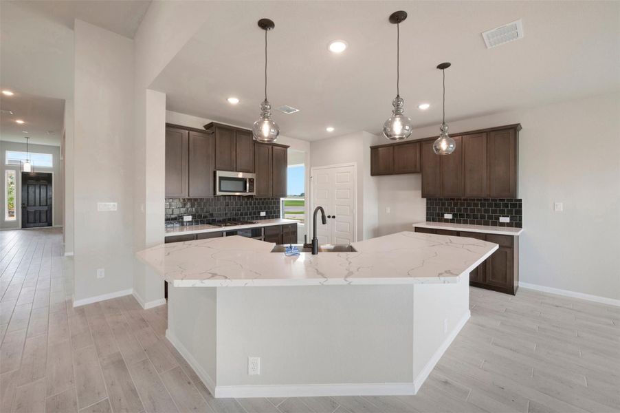 Chef-worthy kitchen with lowered bar top (*Photo not of actual home and used for illustration purposes only.)