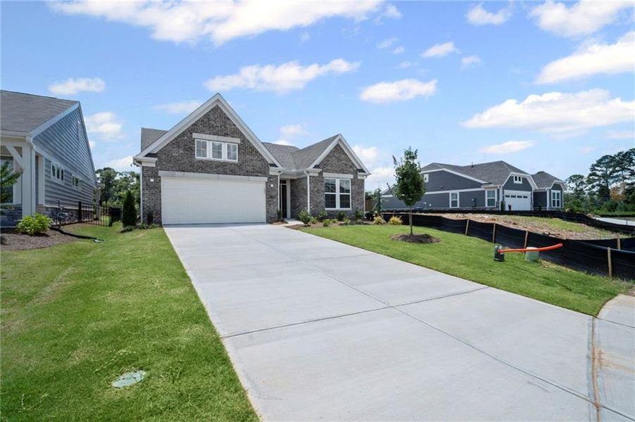 Front exterior of a new home in Laurel Farms, Dallas, GA, highlighting curb appeal (Image 27).