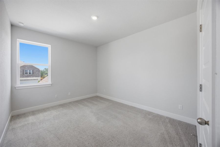 A well-lit bedroom offering a serene and comfortable living space.