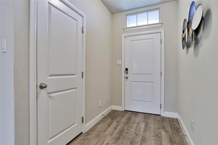 Foyer with light wood-type flooring and baseboards Foyer with light wood-type flooring and baseboards