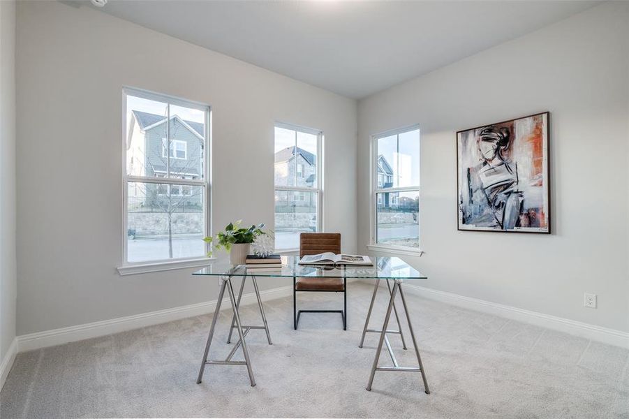 Home office with light colored carpet