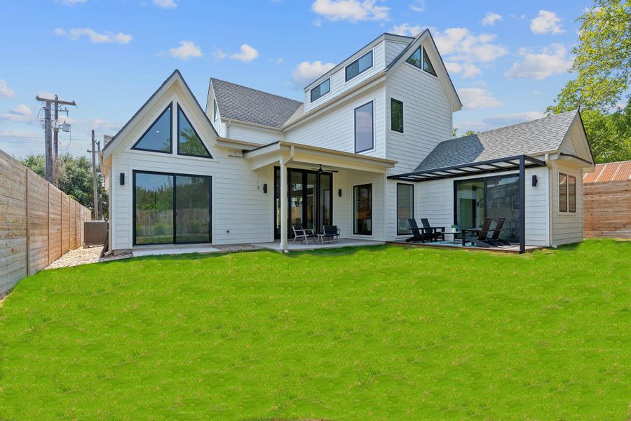 Back of house with a yard, a fenced backyard, and a patio