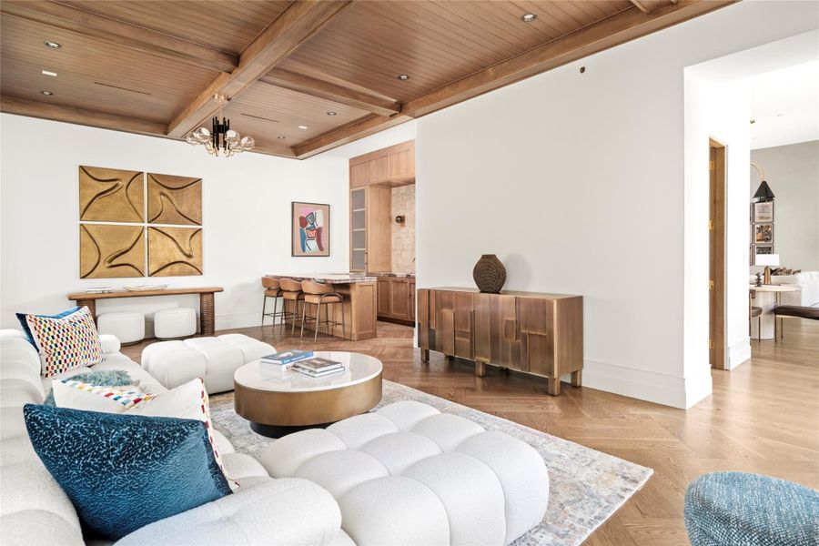 The game room is designed as a sophisticated gathering space, with a richly detailed wood ceiling, herringbone white oak floors, and a dedicated bar for effortless entertaining. Generous proportions allow for multiple seating areas while maintaining an easy, comfortable flow. The game room is designed as a sophisticated gathering space, with a richly detailed wood ceiling, herringbone white oak floors, and a dedicated bar for effortless entertaining. Generous proportions allow for multiple seating areas while maintaining an easy, comfortable flow.