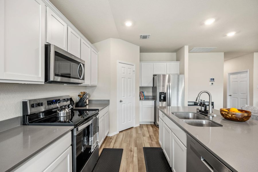 Culinary delights await in this bright kitchen with modern stainless steel appliances and ample counter space.