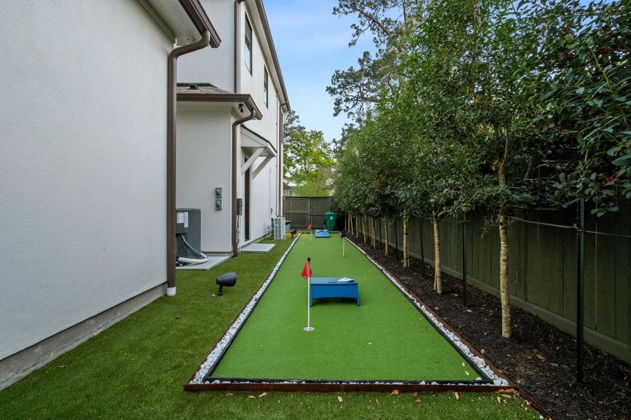 Private putting green with low-maintenance turf, offering a fun and functional extension of the outdoor space.