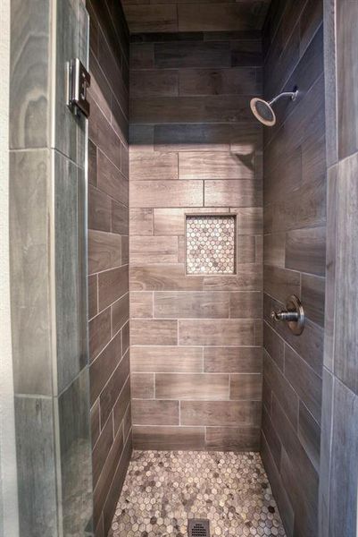 Bathroom featuring a tile shower