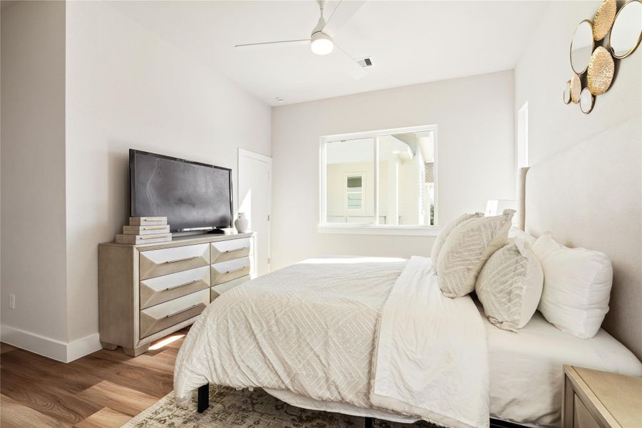 An additional view of the primary suite reveals the secondary closet, thoughtfully separated to keep storage organized without sacrificing the room’s clean, uncluttered feel.