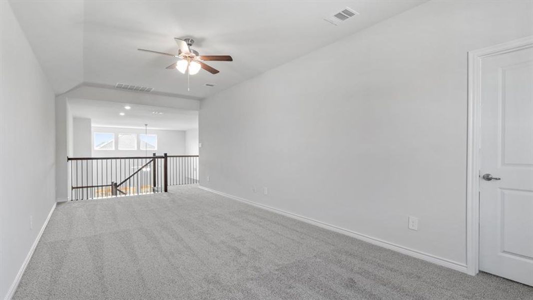 Spare room with carpet flooring and ceiling fan