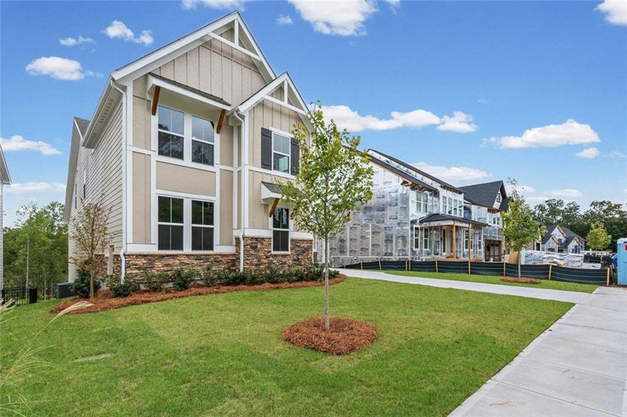 Front exterior of a new home in Twin Lakes, Hoschton, GA, highlighting curb appeal (Image 2). Front exterior of a new home in Twin Lakes, Hoschton, GA, highlighting curb appeal (Image 2).
