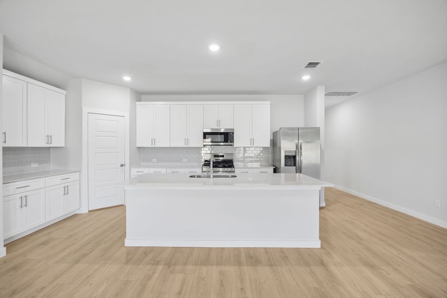Kitchen in the Heisman home plan by Trophy Signature Homes – REPRESENTATIVE PHOTO Kitchen in the Heisman home plan by Trophy Signature Homes – REPRESENTATIVE PHOTO