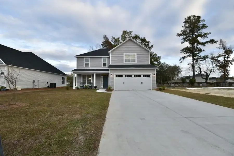 Front exterior of a home in the Bell Meadows community, located in Winnabow, NC (Image 3).