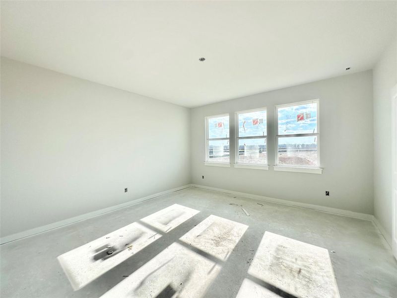 Unfurnished room featuring baseboards and unfinished concrete flooring Unfurnished room featuring baseboards and unfinished concrete flooring