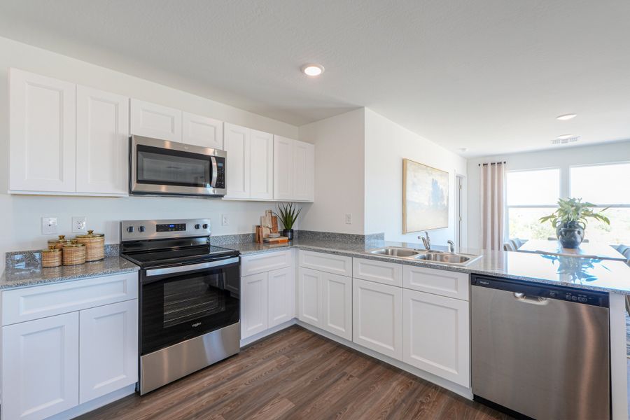 A kitchen with white cabinets. A kitchen with white cabinets.
