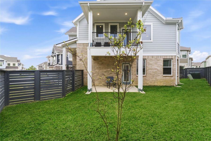 Private backyard with plenty of green space for pets, play, or gardening.