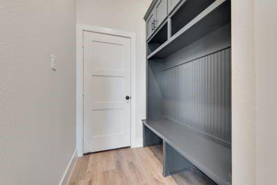 Mudroom with wood-type flooring