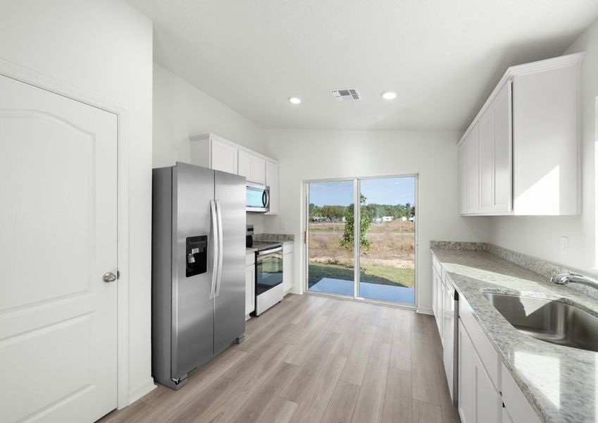 The kitchen flows seamlessly into the back yard